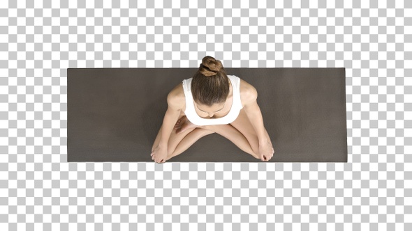 Young Sporty Woman Practicing Yoga Sitting in Lotus Pose And