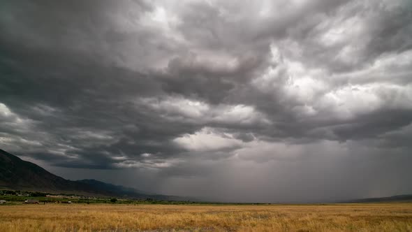 Timelapse of dramatic storm brewing over grain field alt
