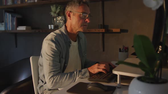 Man using computer at home at night