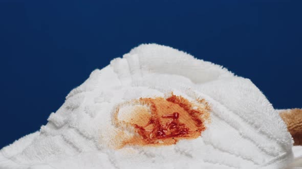 White Towel with Stains on Blue Background Closeup