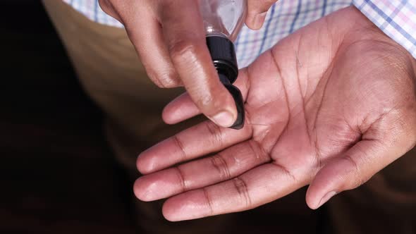 Top View of Young Man Hand Using Sanitizer Gel for Preventing Virus 