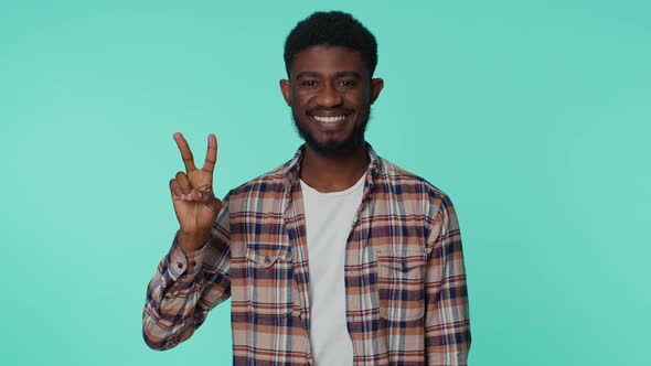 African American Smiling Man Showing Victory Sign Hoping for Success and Win Doing Peace Gesture