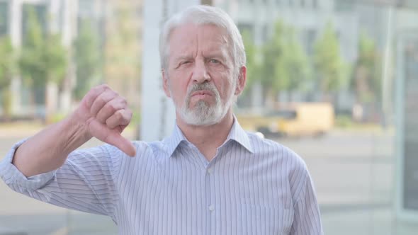 Thumbs Down By Old Man Standing Outdoor