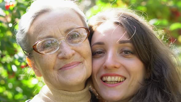 Happy Senior Mother in Eyeglasses is Hugging Her Adult Daughter the Women are Enjoying Together