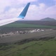 View of the Wing of a Flying Plane in Sunny Weather Over Fields Mountains and Settlements - VideoHive Item for Sale