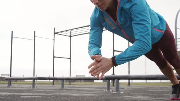 Sporty Caucasian woman exercising in an outdoor gym during daytime