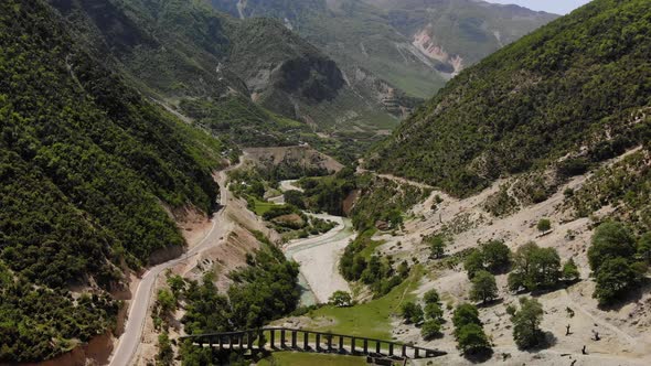 Aerial Drone Footage View Flight Over Mountain with Forests Fields and River