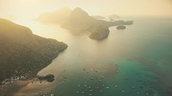 Sunset at Mountainous Islands at Ocean Harbor with Dark Silhouette