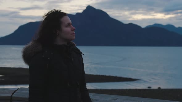 Adventurous Adult Woman Taking in the View of Pacific Ocean Coast