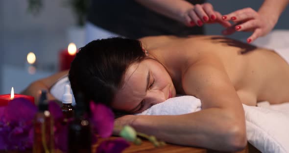 Relaxed Woman Getting Back Massage in Wellness Center