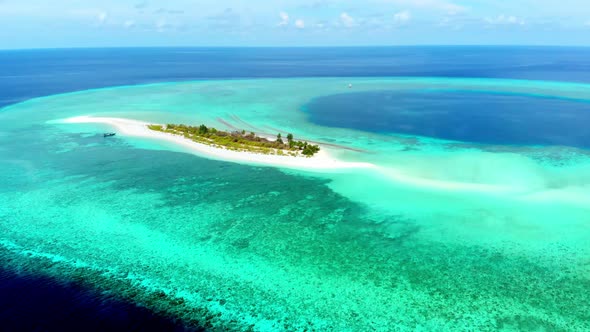 Aerial: Flying over idyllic atoll, exotic travel destination in Wakatobi National Park, Indonesia