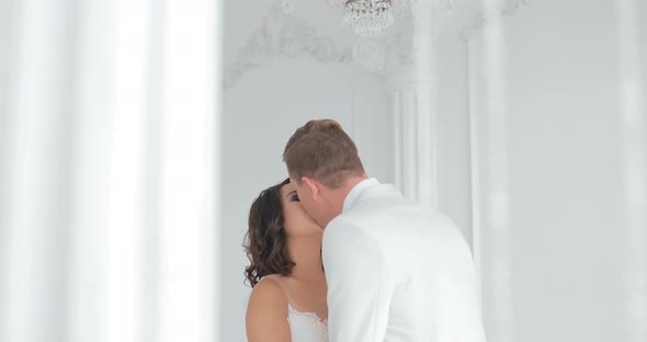 Bride and Groom Kissing Wedding Couple Indoors Looking at Each Other Beautiful Girl Model in White