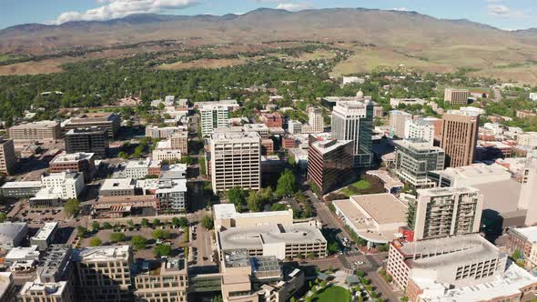 Wide drone shot of Boise, Idaho's downtown sector surrounded by arid farmland.