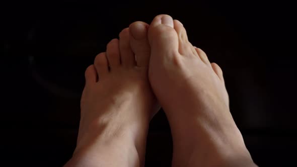 Girl's Feet on the Bed in the Morning