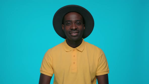 Positive African Guy with Light Smile Posing in Studio