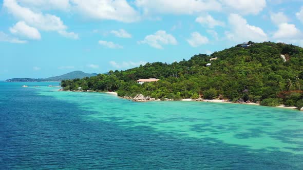 Aerial drone view panorama of exotic coast beach wildlife by blue water and white sandy background o