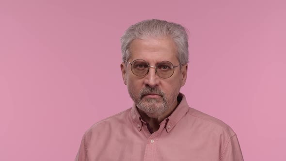 Portrait of an Elderly Man Looking at Camera with Excitement Then Delighting with Screaming