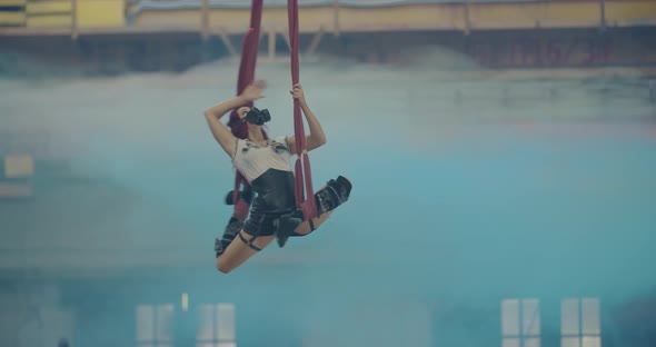 Amazing Flexible Woman is Doing Aerial Gymnastics Blue Smoke