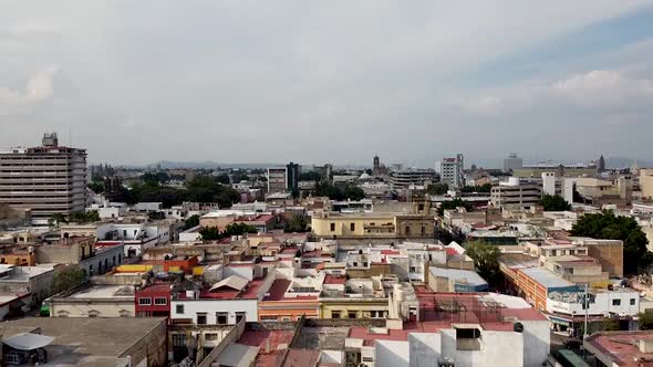 A rising aerial drone shot from the midtown of Guadalajara in Mexico