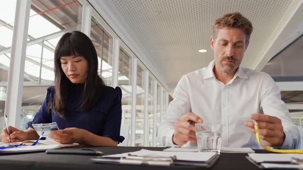 Two colleagues preparing name tags at a business conference