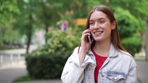 Girl is calling on mobile phone looking away 