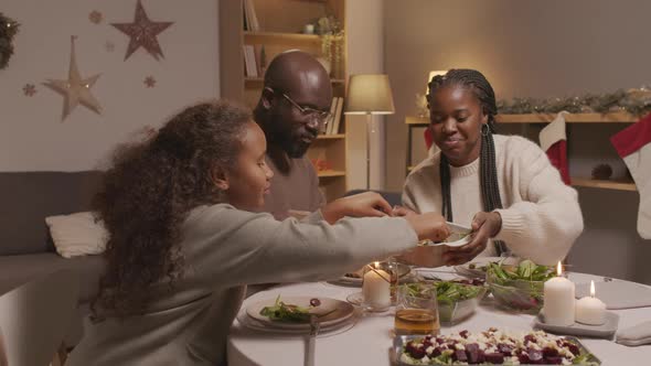 Cheerful Family of Three Enjoying Christmas Dinner