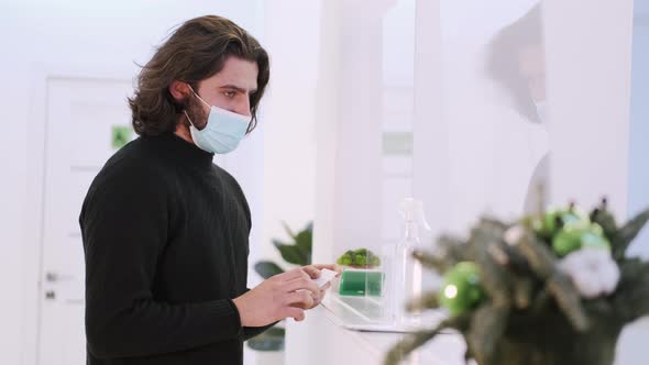 Patient In Mask Conversing At Hospital Reception Desk