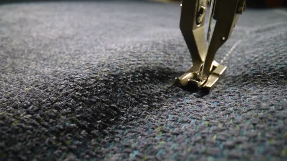 Movement of Foot and Needle While Sewing Gray Woolen Fabric with Sewing Machine