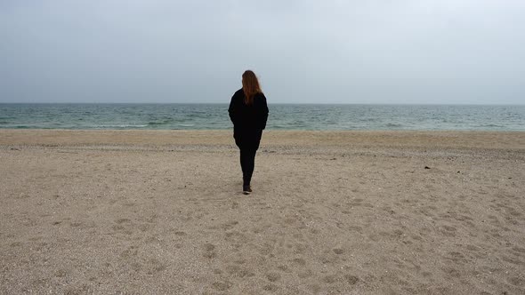 The Girl Walks on the Beach