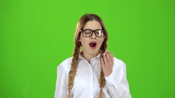 Student with Spectacles Yawns. Green Screen. Slow Motion