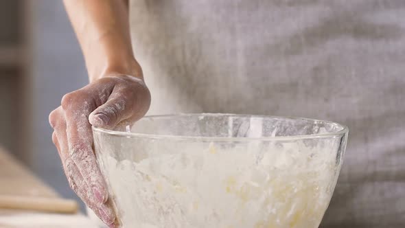 Female Culinary Putting Eggs Into Bowl with Flour Preparing Dough Slow Motion