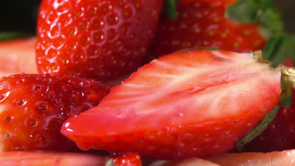 Drop of Water Drips on the Half Ripe Strawberry