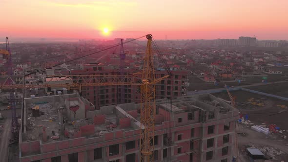 Construction Site in the Middle of the City and Private Houses at Sunset