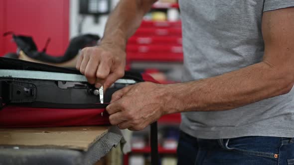 Car Seat Upholstery Repair in Workshop, Workers Hands Using Knife