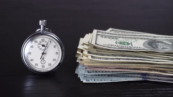 Dollars and stopwatch. Business concept of lost time and failed investments