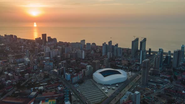 Aerial hyperlapse of Dinamo Batumi Stadium near Heroes Square against cityscape