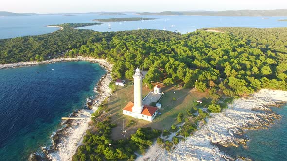 Aerial view of lighthouse, Croatia on forested shore