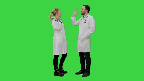 Doctors Friends Give Each Other Five and Thumb Up on a Green Screen, Chroma Key.