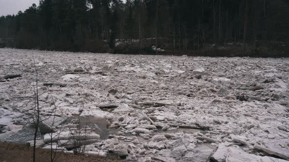 Ice Loads Drift in the River Ogre, Latvia. Stedicam Shot in Snowy Mart Day.