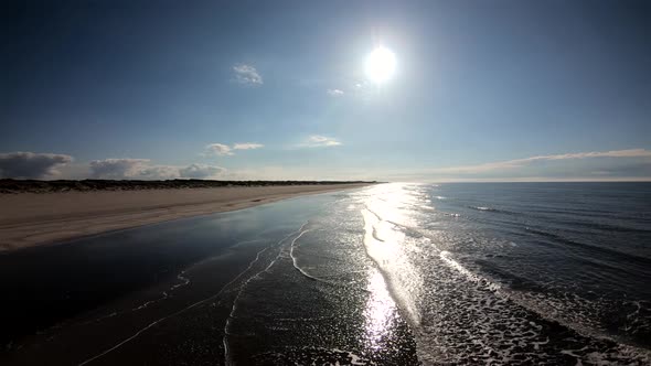 Beautiful ocean waves crashing on the shore on a perfect sunny day aerial footage