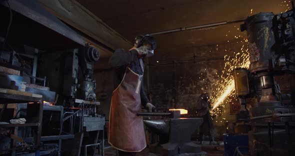 Blacksmith Forges Red-hot Metal From the Furnace