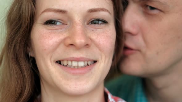 A Man Whispers in the Ear of a Woman, Emotions on Her Face