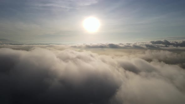 Aerial sliding over the cloud in sunrise