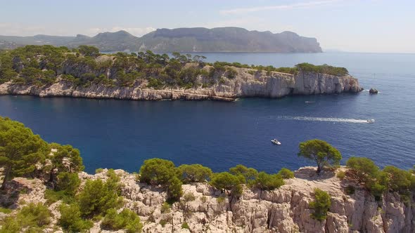 Aerial travel drone view of clear green water, cliffs of Cassis, Mediterranean Sea, Southern France.