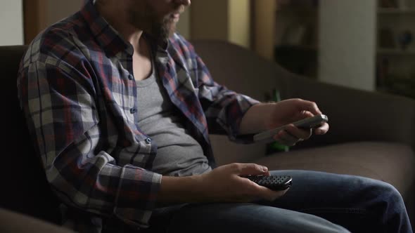 Guy Sitting on Couch, Using Remote Control for Tv Set, Getting Angry, Emotions