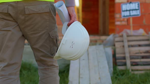 Real Estate Foreman Designer Building Project Architect with Helmet Walking to Construction Site