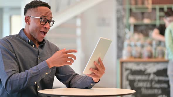 Ambitious Casual Young Man Celebrating Success on Smart Phone