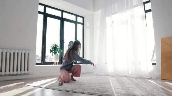 Modern Dancing  a Young Woman Turns on the Music on Her Phone and Starts Dancing