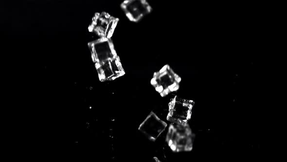 Super Slow Motion Ice Cubes Fall on the Table with Splashes