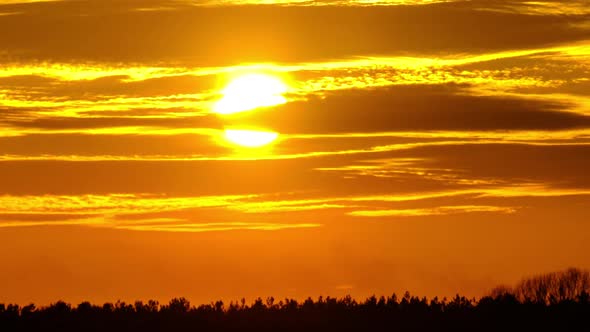 Sunset in the Sky Through Yellow Layered Clouds Timelapse